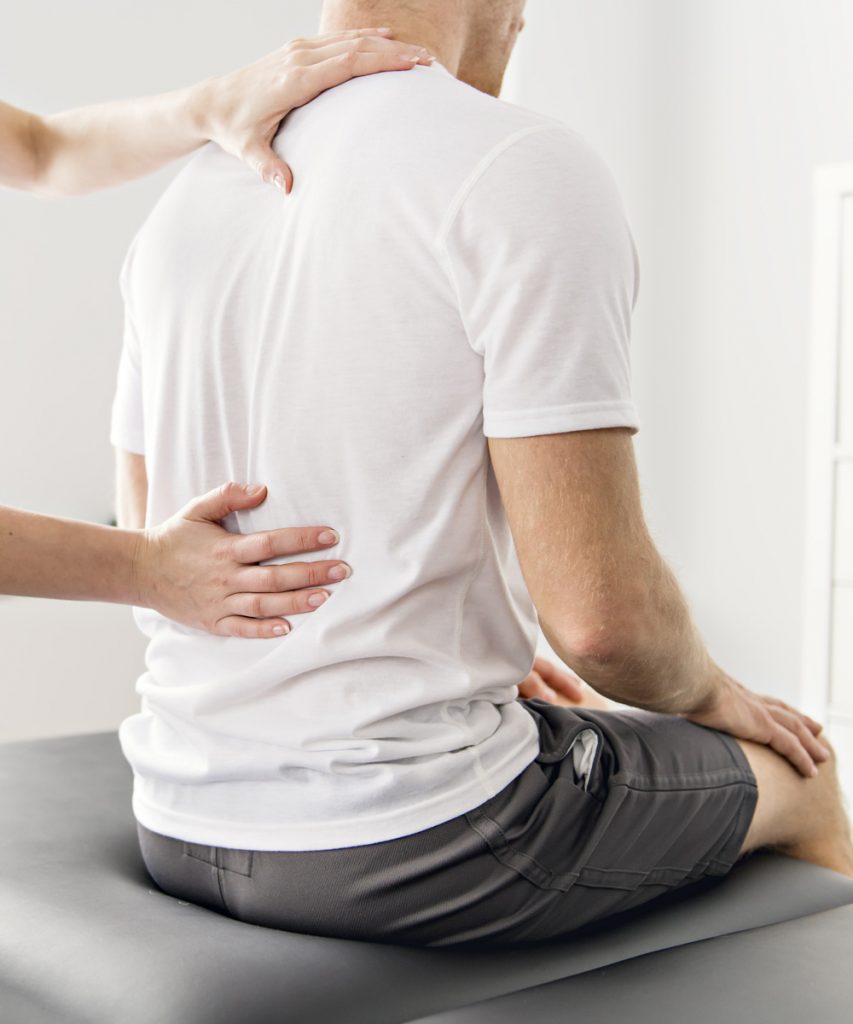 Man getting his back looked at by a doctor